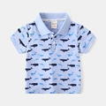 Flat lay of a light blue kids short sleeve polo shirt with all-over whale prints - Sky Blue / 90cm