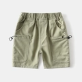 Detail of light green boys cargo shorts featuring elastic waist and drawstring pockets - Light Green / 90cm