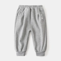 Detail view of children's grey joggers featuring elastic waistband and ribbed ankle cuffs - 90cm / Gray