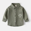Close-up of olive green boys twill shirt featuring a chest pocket with TAKE TIME print - 100cm / Green