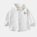 Close-up of white cotton shirt featuring a cartoon crocodile print and WAPYPY brand label - 90cm / White