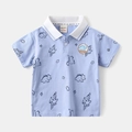 Detail of baby boy light blue polo shirt with dinosaur print and embroidered patch - 90cm / Blue