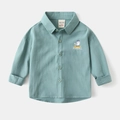 Close-up of seagull embroidery on mint green kids shirt with brand and size label - 90cm / Green