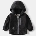 Close-up of black windproof jacket with white dinosaur skeleton and ROAR text print - Black / 90cm