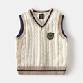 Macro detail of V-neck cable knit kids vest with navy stripes and a crown shield badge - 90cm / Off White