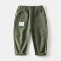 Detail of kids cargo pants showing elastic waistband and large side pockets in olive green - Army Green / 90cm