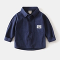 Close-up of deep blue boy's shirt with chest pocket and decorative sport label detail - Navy Blue / 90cm