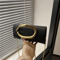 Elegant black faux leather clutch bag with large gold oval buckle and gold chain strap - Black