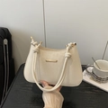 Chic cream white leather underarm bag with gold metal trim and knotted strap detail - White