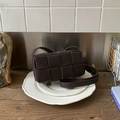 Detail of dark brown square woven handbag with wide leather weave on ceramic plates - Brown
