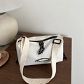 Chic beige crossbody dumpling bag with black FANYISSA logo and adjustable strap - White
