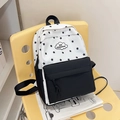 Black and white star print backpack with high capacity and cloud logo on a yellow chair - Black
