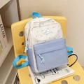 Blue and white star pattern school backpack with cloud patch on a yellow chair - Blue
