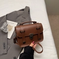 Vintage brown messenger style handbag with top handle and adjustable strap in retro aesthetic - Brown