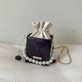 Fashionable purple snakeskin bucket bag with pearl handle and golden chain strap - Purple