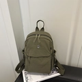 Minimalist military green nylon backpack featuring multiple zippers and metallic M logo - Green