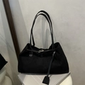 Minimalist black canvas tote bag with slim leather straps and metal buckle detail - Black