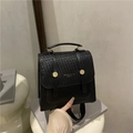 Fashionable black woven leather backpack for women with gold buckles and top handle - Black