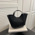 Minimalist black leather bucket bag with vertical stitching and dual handles - Black