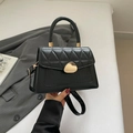 Black quilted handbag with crocodile texture and gold hardware for commute - Black
