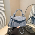 Light blue denim handbag with knotted top handle and stylish crossbody strap design - Blue
