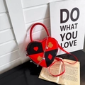 Heart shaped cross pattern shoulder bag with poker card prints and metal chain straps - Red