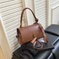 Vintage dark brown crossbody handbag with a decorative top handle and a gold twist lock - Brown