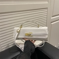 White faux crocodile skin baguette bag with gold metal buckle and adjustable shoulder strap - White