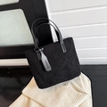 Minimalist black fleece bucket handbag with premium faux leather handles and fashion tag - Black