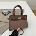 Deep brown Kelly style handbag featuring leather and fabric patchwork with gold metal clasp - Brown