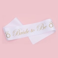 Detail of white satin Bride to Be sash with gold lettering and ring icons for weddings - Satin Sash / White Gold Text-Bride to Be