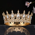 Macro view of luxurious gold bridal crown with crystal stones on reflective black surface - Gold White