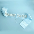 Light blue satin Bride To Be sash with white pearl lettering and safety pins - Light Blue Satin Sash (BRIDE TO BE Pearl Rhinestone)