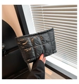 Detail of a black quilted puffer clutch bag with shiny finish and gold zipper closure - Black