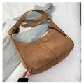 Brown suede hobo bag with adjustable wide strap and decorative drawstring on knit background - Brown