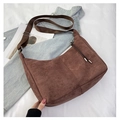 Detail of dark brown suede crescent bag featuring fringe zipper and woven strap - Brown