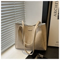 Minimalist beige tote bag with litchi texture and double shoulder straps in soft lighting - Khaki