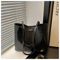 Classic black tote bag with gold lettering and faux leather texture for women - Black
