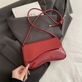 Glossy red patent leather shoulder bag with asymmetrical flap and knotted strap details - Red