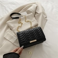 Fashionable black chevron quilted shoulder bag with gold chain strap and metal bar detail - Black