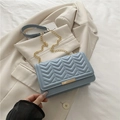 Light blue V-quilted shoulder bag with gold chain strap and metal bar lock closure - Blue
