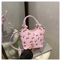 Chic pink shoulder bag with red cherry print featuring a knot handle and long strap - Pink