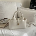 Chic cream white structured tote bag with gold gourd charm and dual carrying handles - White