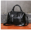 Detalle de bolso Boston de cuero negro granulado con hebilla metálica y correa ajustable - Negro