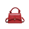 Elegant red structured handbag with knot handle, wavy flap, and gold oval lock closure - Red