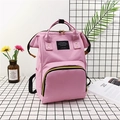 Rosa Canvas Wickelrucksack mit goldenen Reißverschlüssen und gelb-schwarzen Webband-Details - Rosa