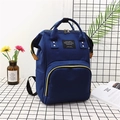 Mochila pañalera de lona azul marino con compartimentos amplios y cremalleras oro - Azul oscuro