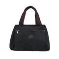 Large black canvas travel bag with brown handles and a vintage shoulder strap - Black