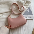 Pink crescent shoulder bag in matte faux leather with gold zipper and slim strap - Pink