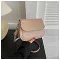 Detail of beige saddle bag showing faux leather texture and crocodile pattern flap - Dark Khaki